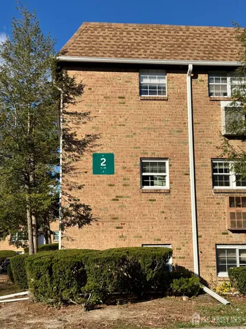 a front view of a house with plants