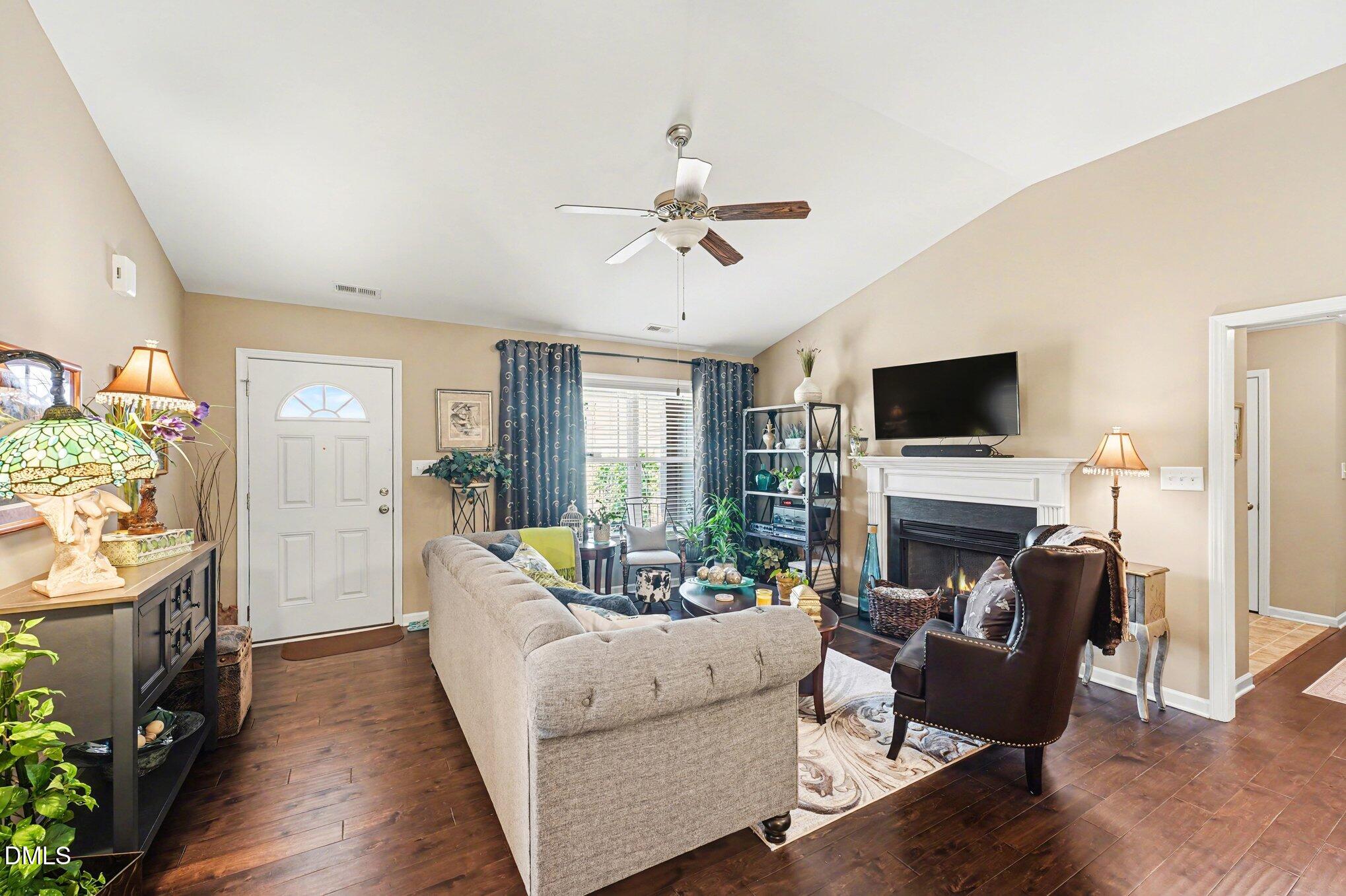 109 His Way Middlesex, NC 27557 - Photo 3 of 21 a living room with furniture a fireplace and a flat screen tv