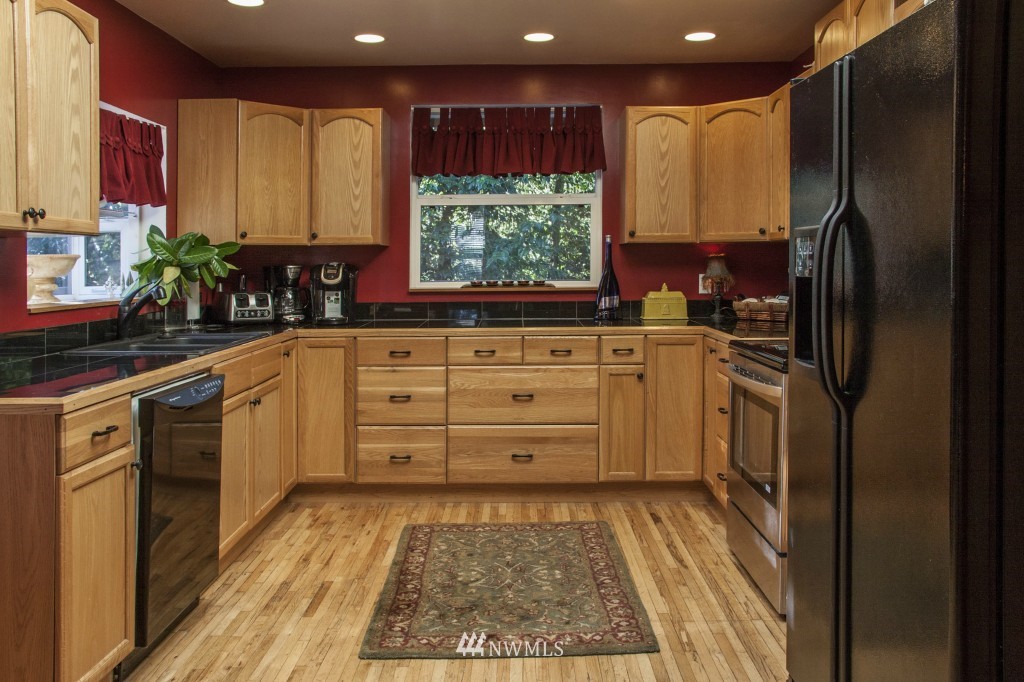 16623 Benson Road South Renton, WA 98055 - Photo 12 of 20 a kitchen with stainless steel appliances granite countertop a refrigerator sink and cabinets