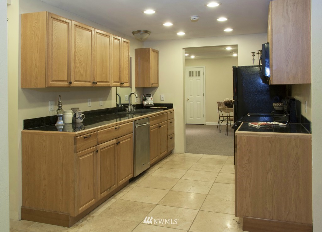 16623 Benson Road South Renton, WA 98055 - Photo 3 of 20 a kitchen with stainless steel appliances a stove a sink and a microwave