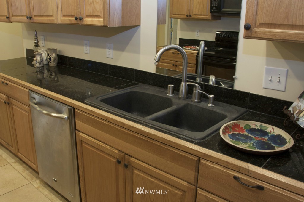 16623 Benson Road South Renton, WA 98055 - Photo 4 of 20 a close view of sink and dishwasher with wooden floor