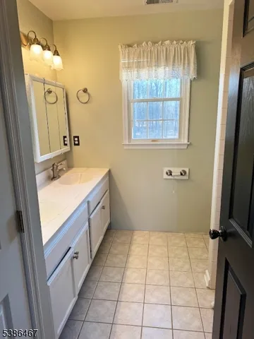 a view of a room with wooden floor and windows