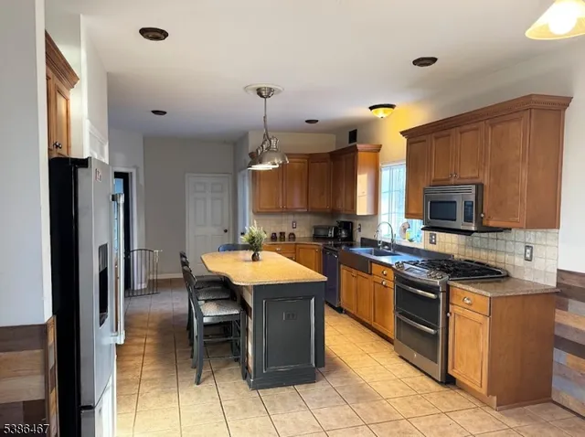 a living room with furniture and floor to ceiling windows