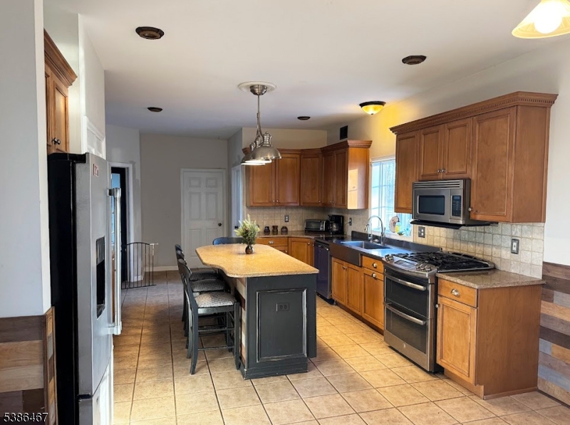 15 Opdyke Road Frenchtown, NJ 08825 - Photo 5 of 27 a kitchen with stainless steel appliances granite countertop a stove top oven a sink dishwasher a dining table and chairs with wooden floor