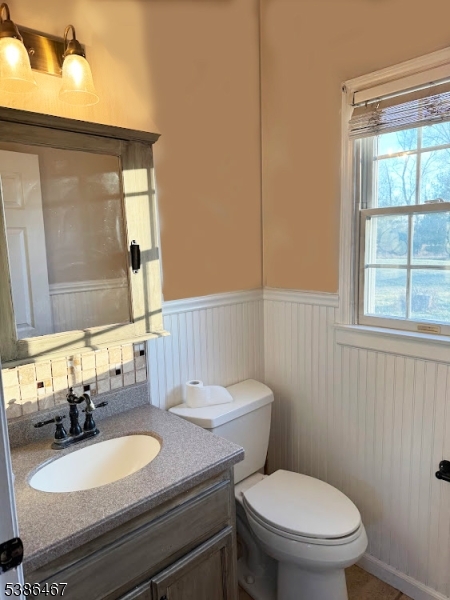 15 Opdyke Road Frenchtown, NJ 08825 - Photo 9 of 27 a bathroom with a granite countertop toilet a mirror and a sink