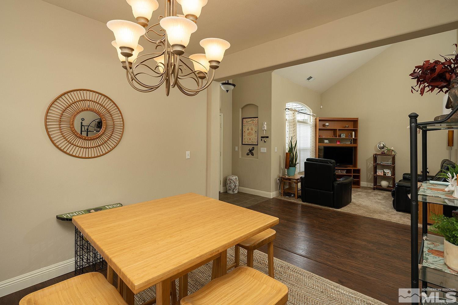 10610 Silver Cliff Way Reno, NV 89521 - Photo 13 of 40 a view of a dining room with furniture a chandelier and wooden floor