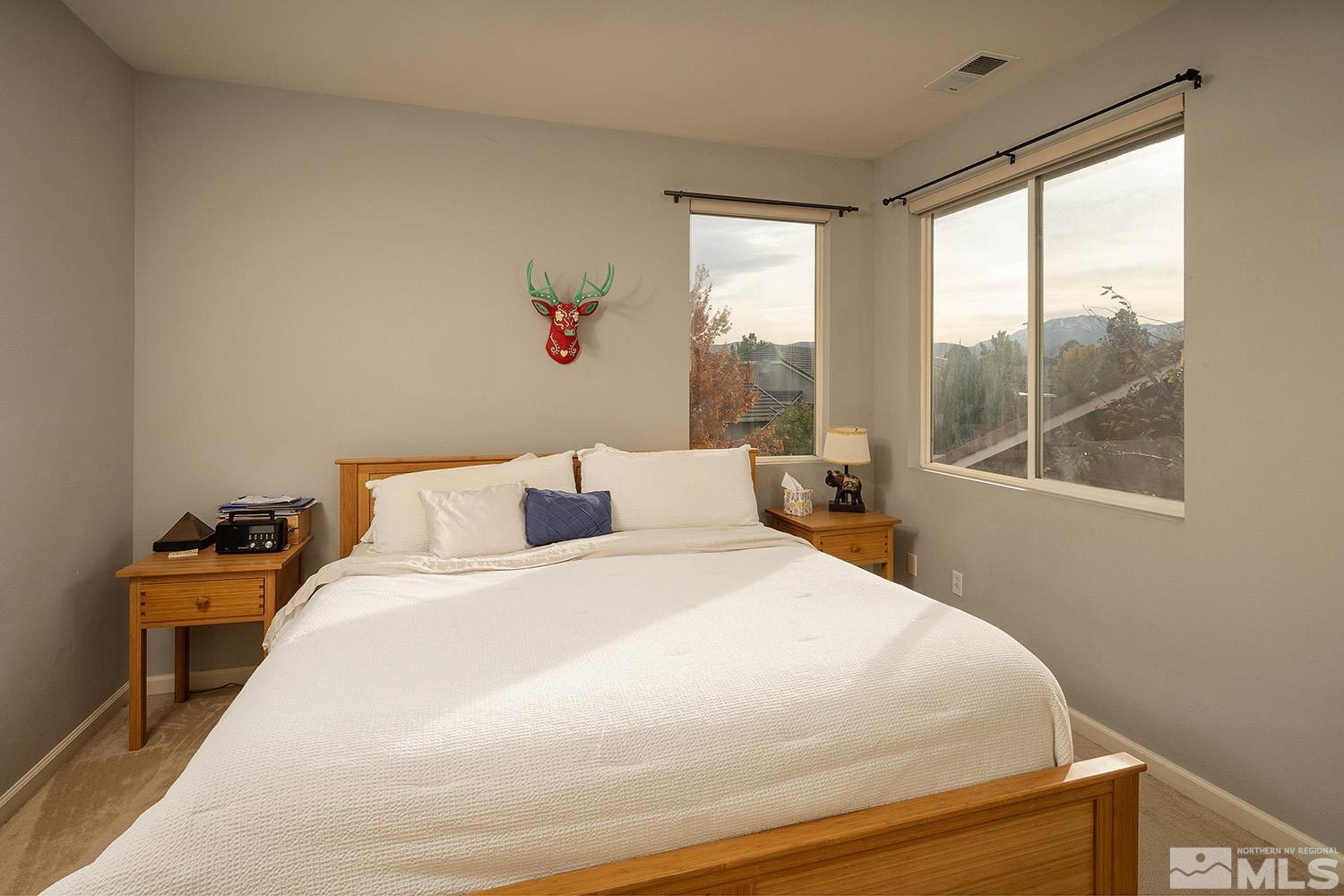10610 Silver Cliff Way Reno, NV 89521 - Photo 18 of 40 a bed sitting in a bedroom next to a window