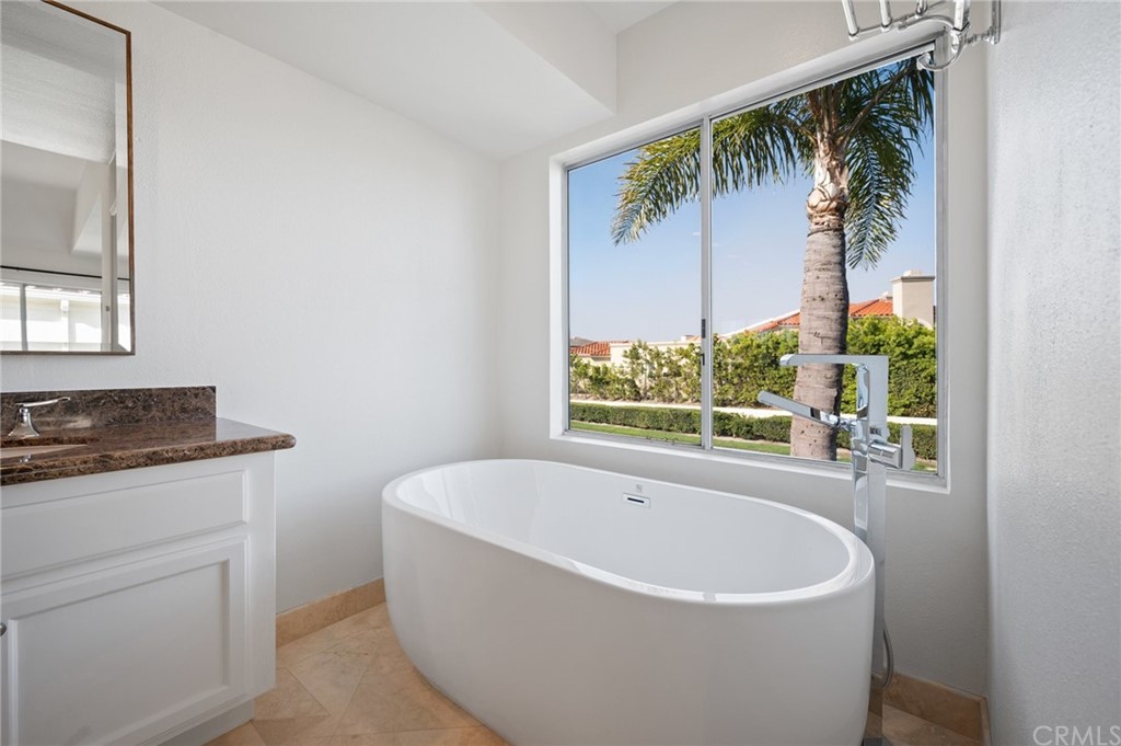 17 St John Dana Point, CA 92629 - Photo 16 of 28 a white bath tub sitting in a bathroom next to a window