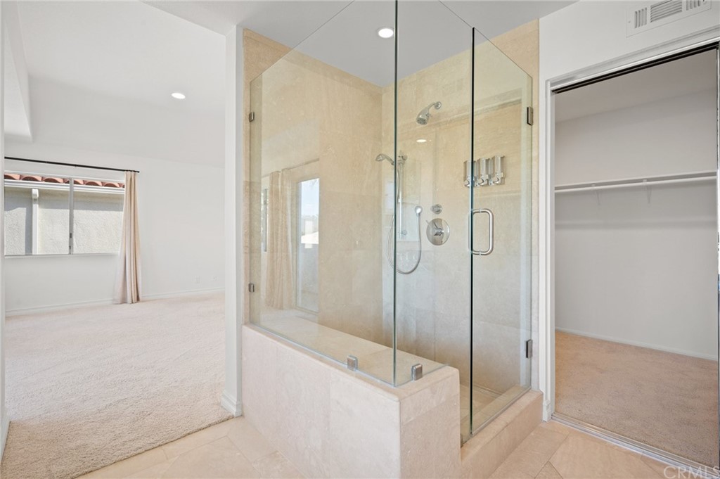 17 St John Dana Point, CA 92629 - Photo 18 of 28 a bathroom with a shower and a glass door