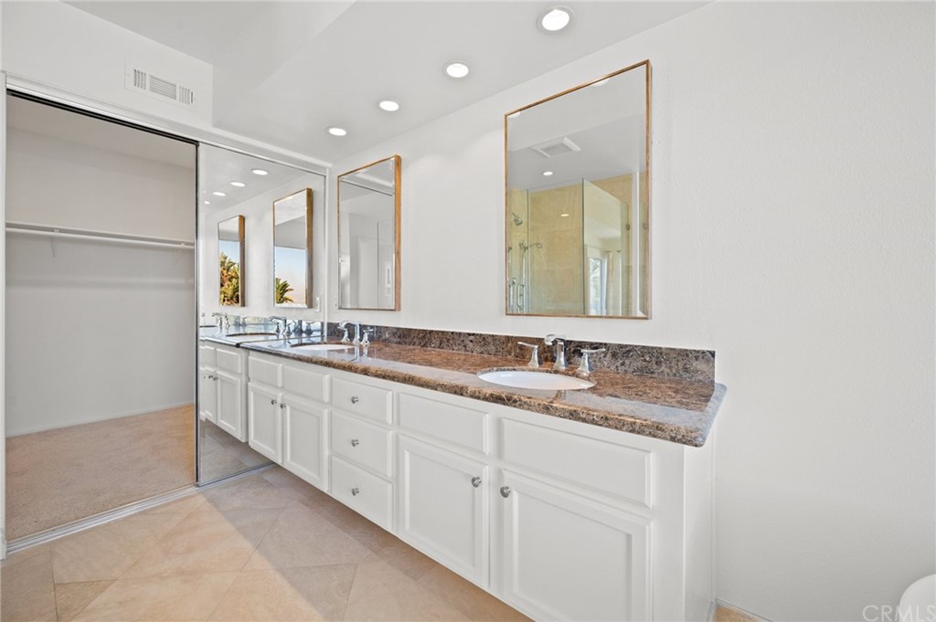 17 St John Dana Point, CA 92629 - Photo 19 of 28 a bathroom with double sink and a mirror