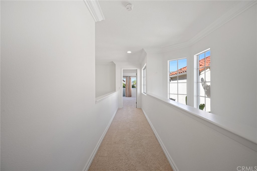 17 St John Dana Point, CA 92629 - Photo 21 of 28 a view of a hallway with wooden floor and a living room