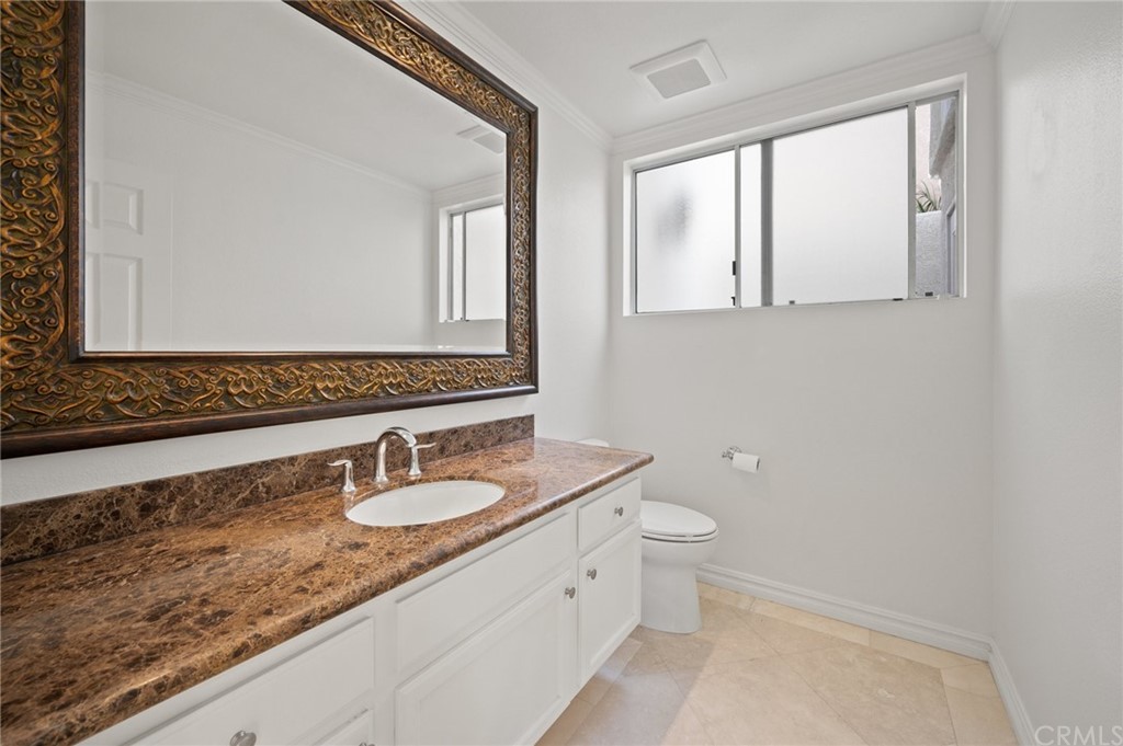 17 St John Dana Point, CA 92629 - Photo 27 of 28 a bathroom with a granite countertop sink and a mirror