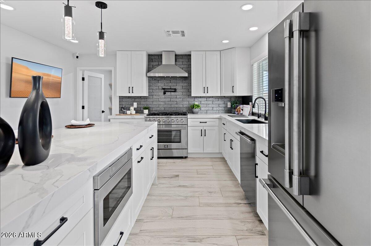 11615 North 30th Street Phoenix, AZ 85028 - Photo 1 of 37 a large kitchen with stainless steel appliances granite countertop a white stove top oven a sink dishwasher and a refrigerator with wooden floor