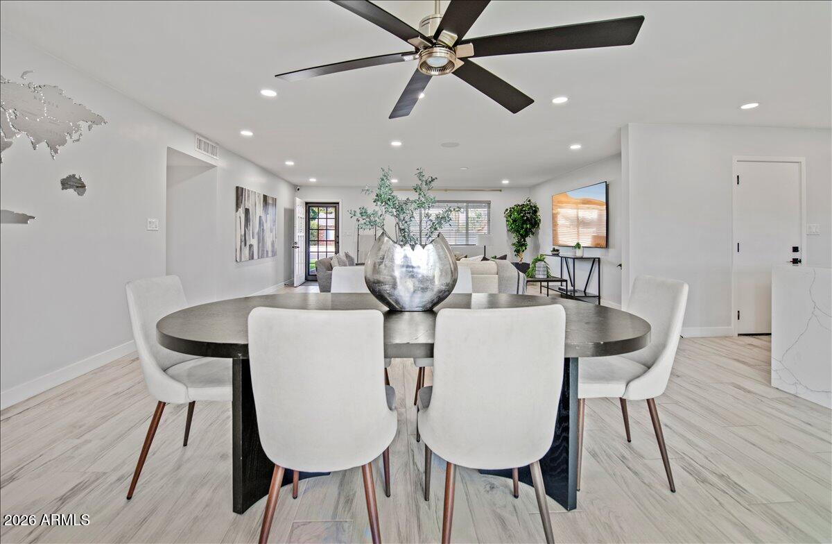 11615 North 30th Street Phoenix, AZ 85028 - Photo 12 of 37 a view of a dining room with furniture and wooden floor