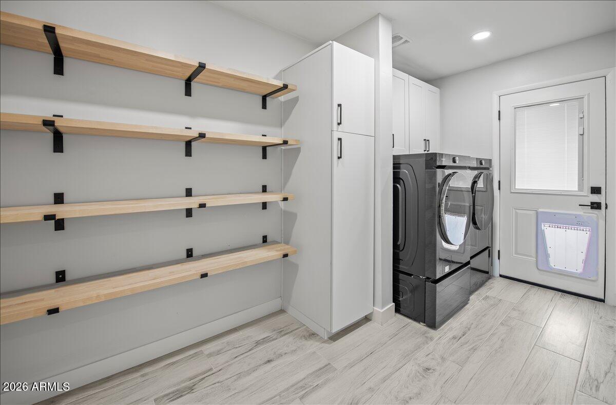 11615 North 30th Street Phoenix, AZ 85028 - Photo 14 of 37 a view of walk in closet with clothes and shoes