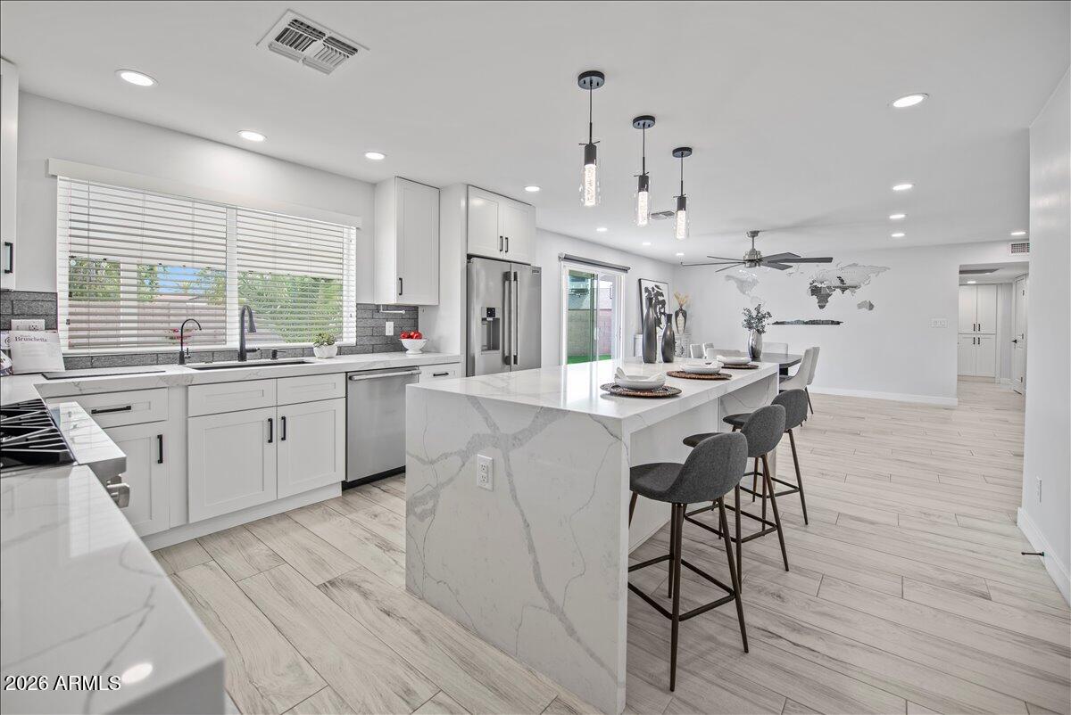11615 North 30th Street Phoenix, AZ 85028 - Photo 15 of 37 a large kitchen with a table and chairs