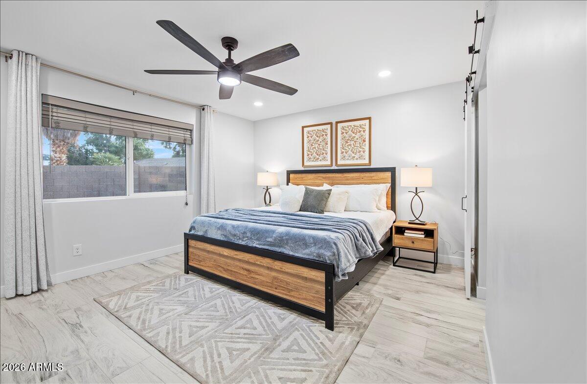 11615 North 30th Street Phoenix, AZ 85028 - Photo 17 of 37 a bedroom with a large bed and a chandelier