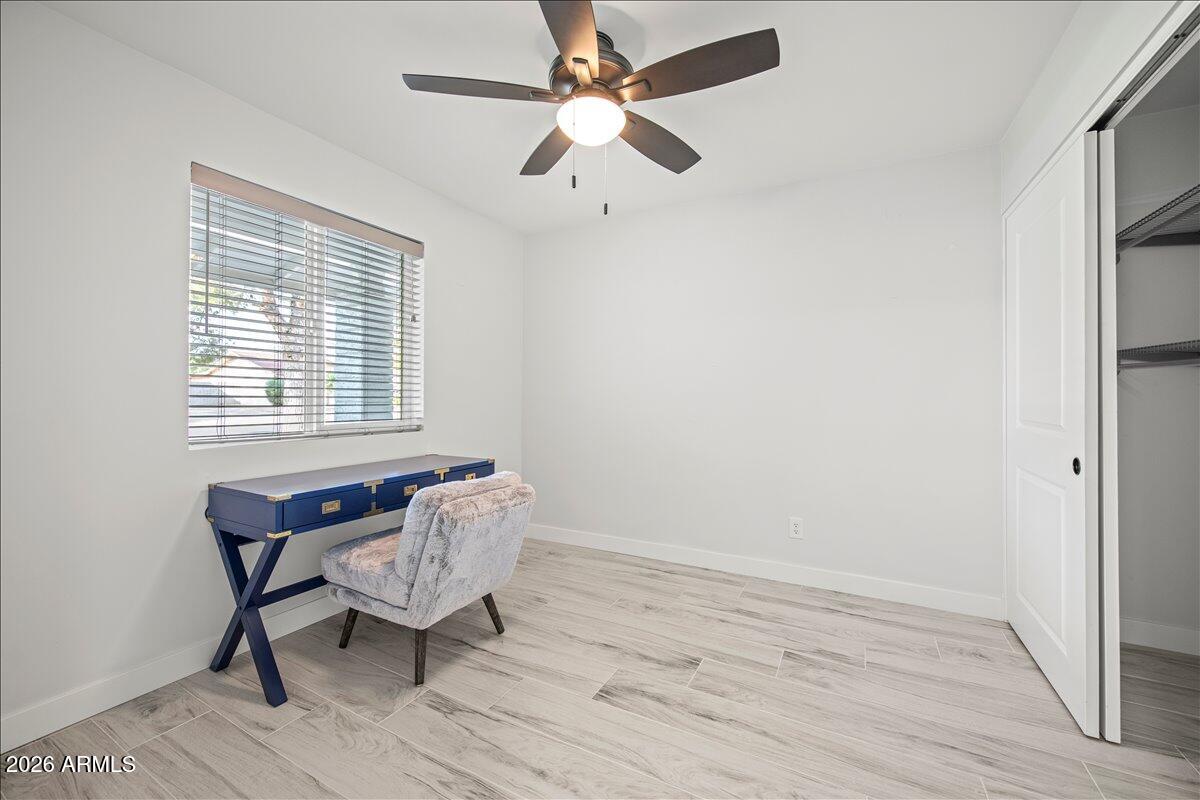 11615 North 30th Street Phoenix, AZ 85028 - Photo 21 of 37 a view of a workspace with wooden floor and a window
