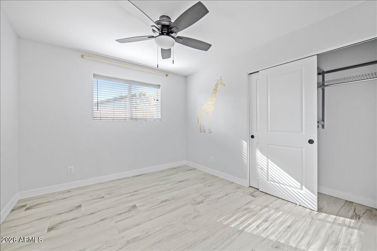 11615 North 30th Street Phoenix, AZ 85028 - Photo 24 of 37 an empty room with wooden floor and windows