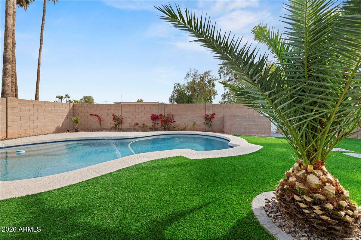 11615 North 30th Street Phoenix, AZ 85028 - Photo 27 of 37 a view of a swimming pool with a yard