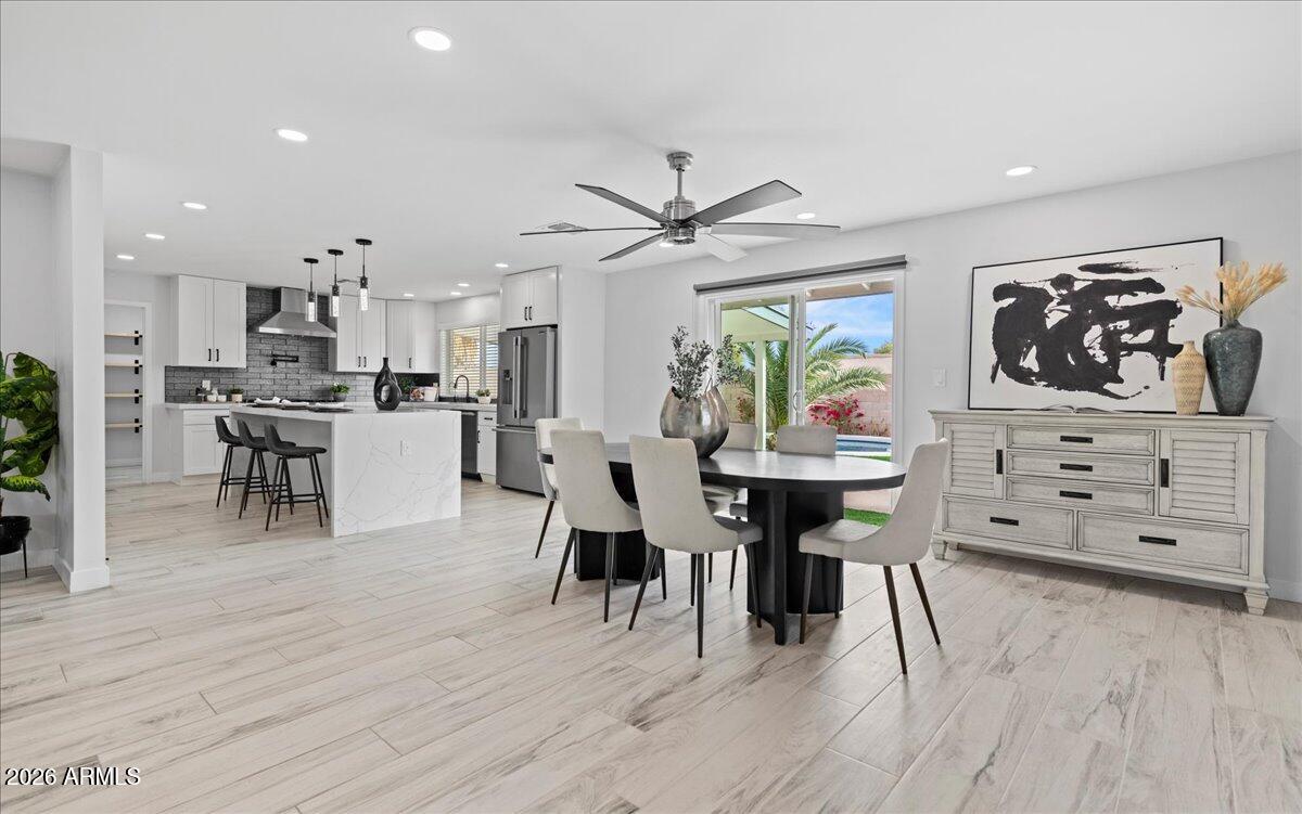 11615 North 30th Street Phoenix, AZ 85028 - Photo 5 of 37 a view of a dining room with furniture and wooden floor