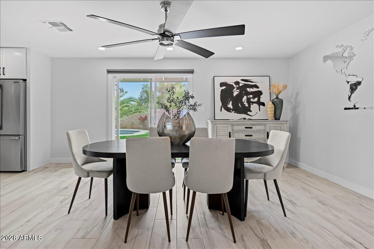 11615 North 30th Street Phoenix, AZ 85028 - Photo 6 of 37 a view of a dining room with furniture window and wooden floor