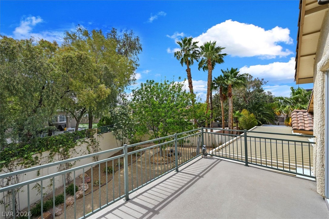 1259 Moon Vision Street Henderson, NV 89052 - Photo 15 of 53 A spacious private balcony overlooks lush mature landscaping and verdant trees.