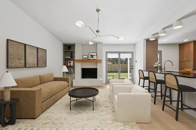 a living room with furniture a table and a fireplace