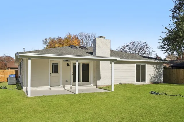 a view of a house with a yard and porch