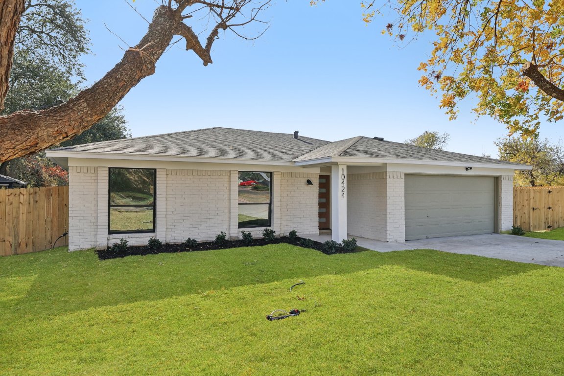10424 Quail Ridge Drive Austin, TX 78758 - Photo 33 of 37 View of front of home featuring brick siding, concrete driveway, roof with shingles, and an attached garage