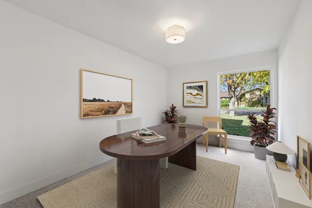 a view of a big room with wooden floor a kitchen view and a window
