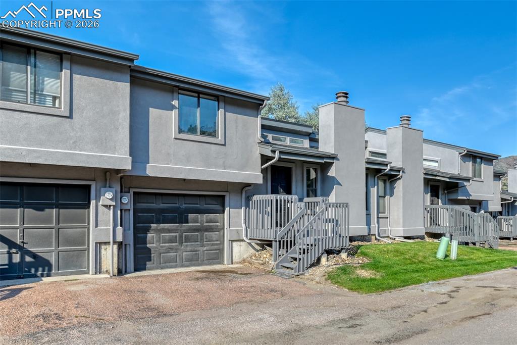 1591 Territory Trail Colorado Springs, CO 80919 - Photo 2 of 13 a front view of a house with garden