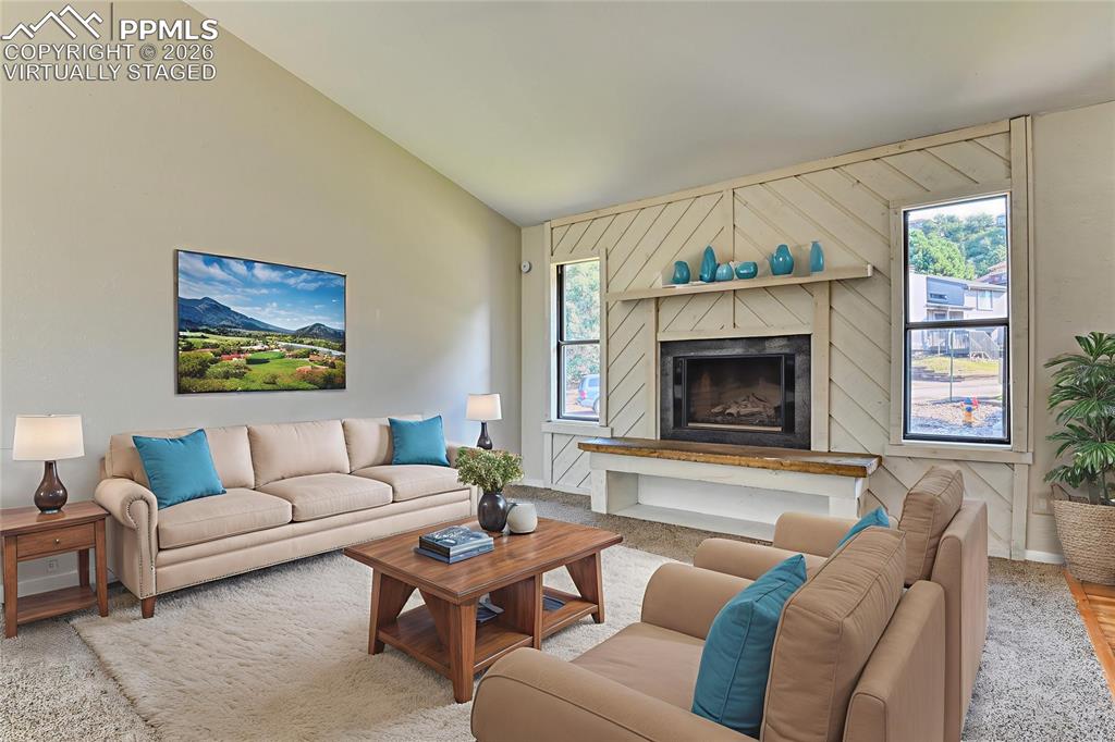 1591 Territory Trail Colorado Springs, CO 80919 - Photo 6 of 13 a living room with furniture a fireplace and a large window