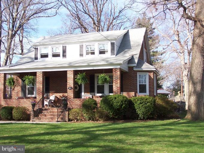 a front view of a house with garden and porch