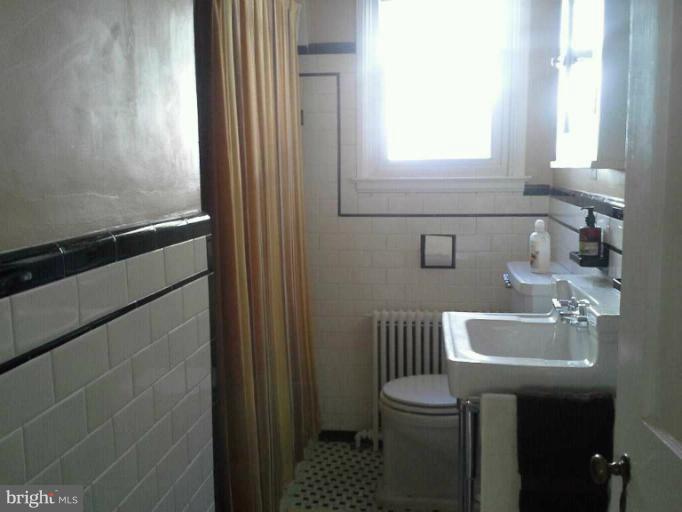 421 Rolling Rd. Catonsville, MD 21228 - Photo 14 of 26 a bathroom with a sink a toilet and a mirror