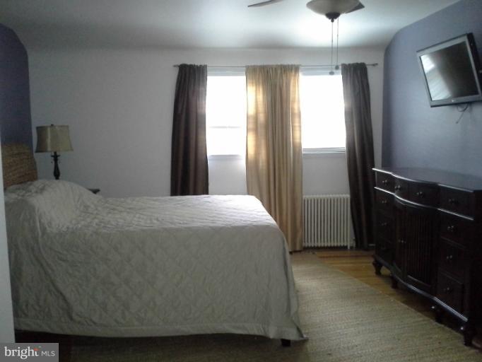 421 Rolling Rd. Catonsville, MD 21228 - Photo 17 of 26 a bed sitting in a bedroom next to a window