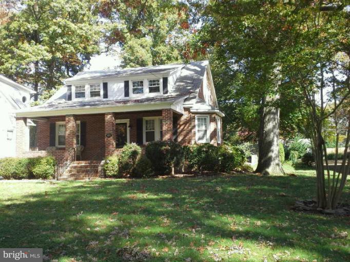 421 Rolling Rd. Catonsville, MD 21228 - Photo 21 of 26 a front view of a house with garden and trees