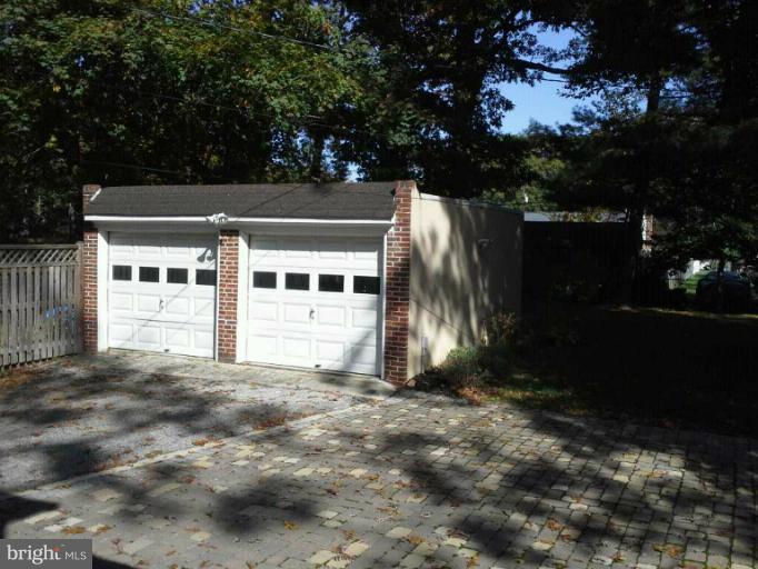 421 Rolling Rd. Catonsville, MD 21228 - Photo 22 of 26 a view of backyard with large trees and wooden fence