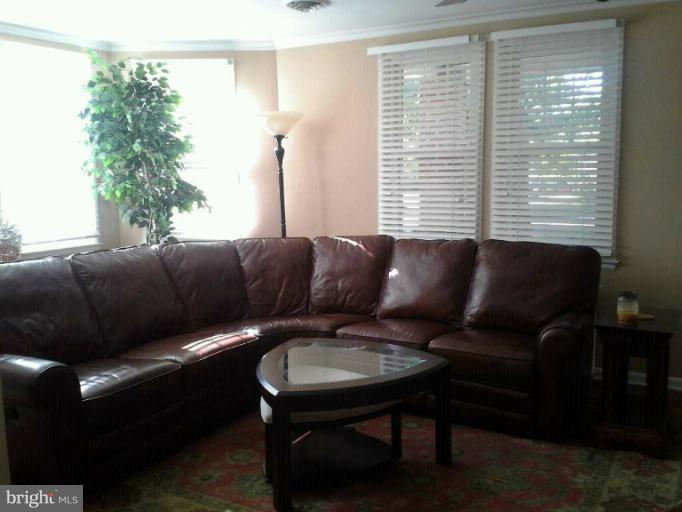 421 Rolling Rd. Catonsville, MD 21228 - Photo 8 of 26 a living room with furniture and a large window
