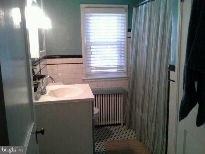 421 Rolling Rd. Catonsville, MD 21228 - Photo 10 of 26 a bathroom with a sink and a mirror