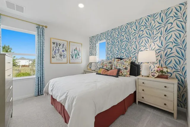 a bathroom with a granite countertop toilet sink and mirror