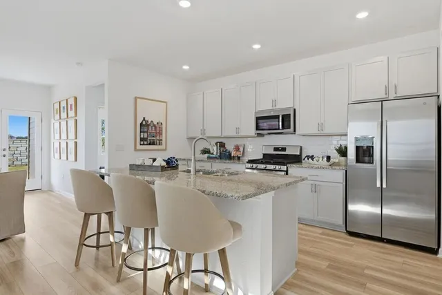 a spacious bedroom with a bed and a chandelier