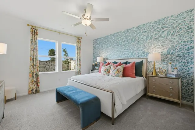 a kitchen with stainless steel appliances granite countertop a stove a sink a microwave a refrigerator and white cabinets with wooden floor