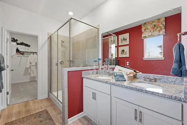 a kitchen with a sink cabinets and wooden floor