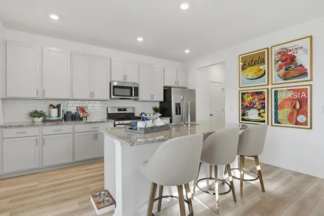 a view of kitchen with sink and refrigerator