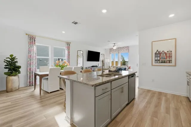 a living room with furniture potted plant and a flat screen tv