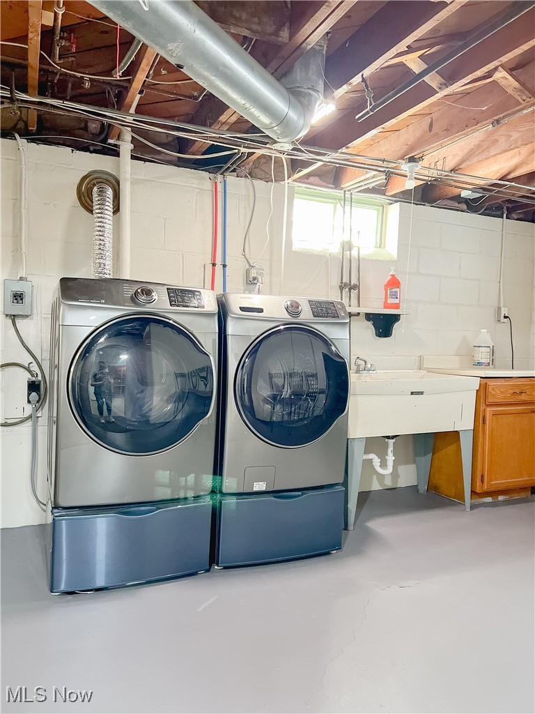 6403 Kenneth Avenue Parma, OH 44129 - Photo 18 of 20 Laundry area featuring concrete floors and washer and dryer