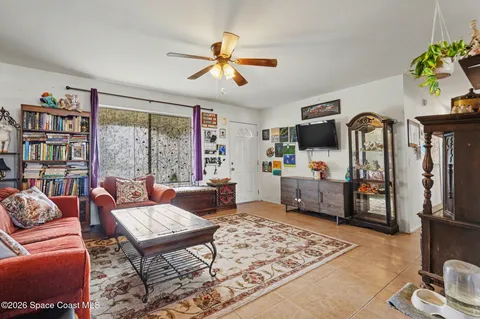a living room with furniture a rug and a large window