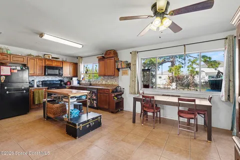a living room with furniture a fireplace and a dining table