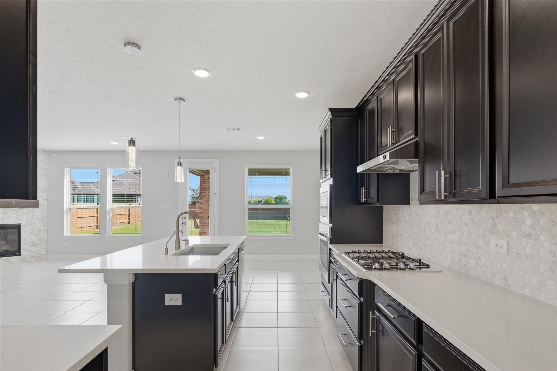 15846 Weston Ridge Drive Humble, TX 77346 - Photo 3 of 22 a kitchen with stainless steel appliances granite countertop a sink a stove and a refrigerator